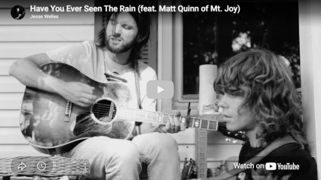 Screenshot of a Youtube cover of two guys sitting on a porch playing guitars.